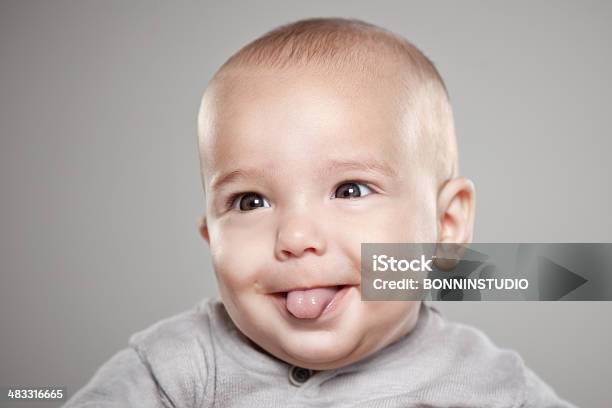 Portrait Of A Baby Sticking His Tongue Stock Photo - Download Image Now - Human Tongue, Newborn, Baby - Human Age
