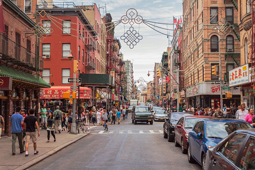 Lovely view of one of the most renowned streets in Chinatown (Mott St), with it's busy shops crowded with tourists strolling on a summer day.