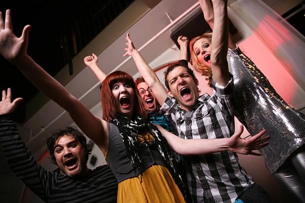 Group of Young People Raising There Hands in Joy.