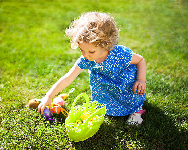 menina em um ovo de páscoa caçam - easter basket eggs yellow - fotografias e filmes do acervo