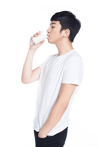 istock young man drinking milk isolated on white background 483318826
