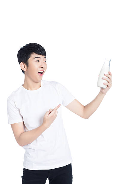 istock smiling young man with a glass of milk 483318828