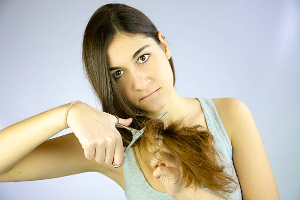 istock Cute girl ready to cut her long hair 483319421