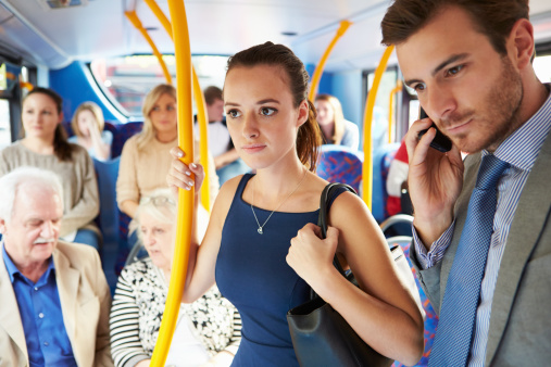 Passengers Standing On Busy Commuter Bus During Morning