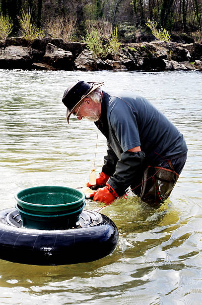 Boucoiran, France - March 16, 2014: Gold digger in France in the region of Cevennes and the department of Gard in the middle of the river called Le Gardon.