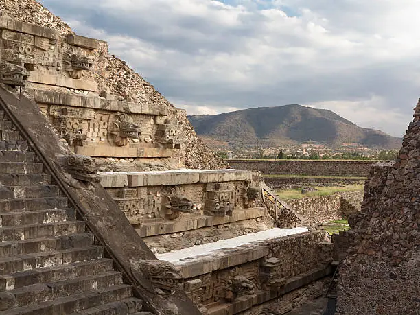 The pyramid of Quetzalcoatl (god of the "feathered serpent") is showing the alternating "Tlaloc" (left, with teeth, a god of rain, fertility, and water) and feathered serpent (right) heads. Dated to some time between 150 and 200 CE, it is part of the Unesco World Heritage site Teotihuacan, Mexico.