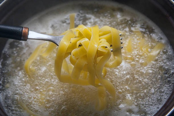 Cooking pasta italian cuisine boiled water stock pictures, royalty-free photos & images