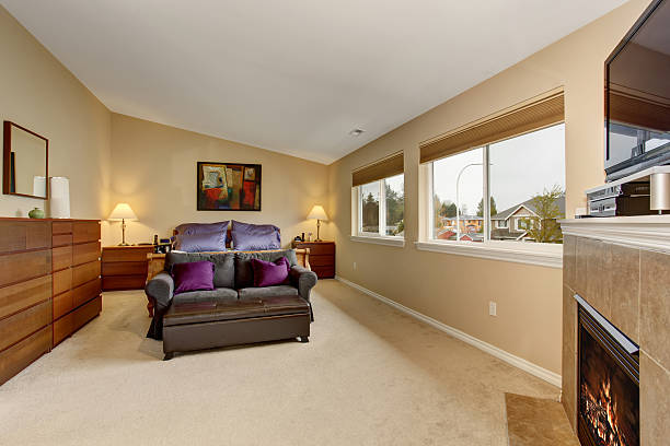 istock Large bedroom with fireplace and tv. 483325404