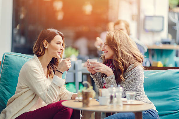 istock Two girls talking in a cafe 483327512