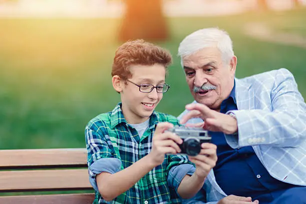 Photo of Grandfather and grandson taking a photo