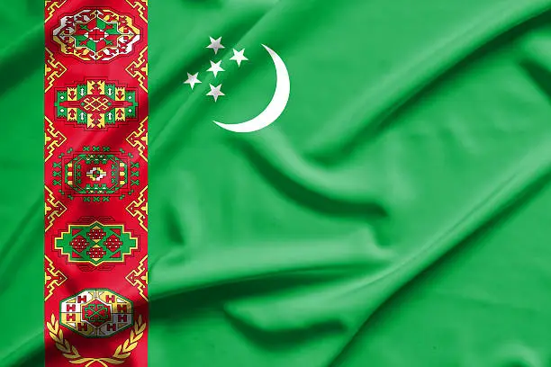 Photo of Turkmenistan flag on soft and smooth silk texture