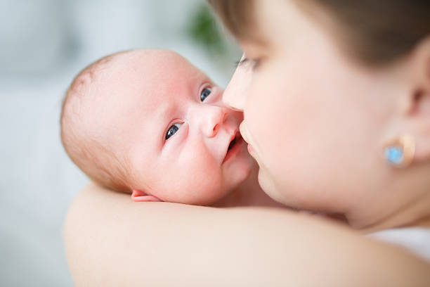 istock Mother and her one month old son close up 483332212