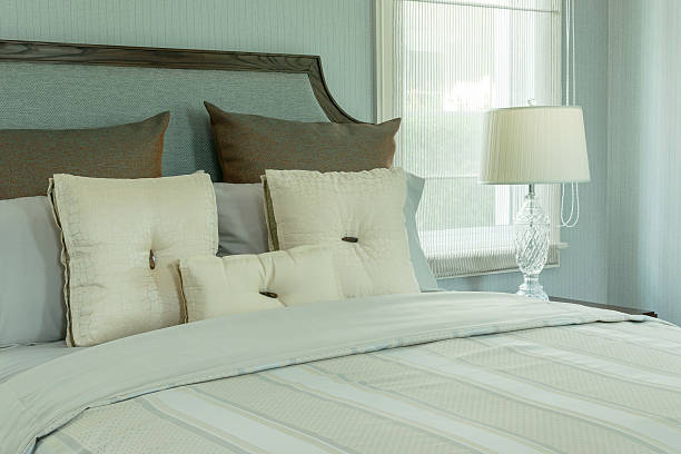 istock cozy bedroom interior with white pillows and reading lamp 483333114