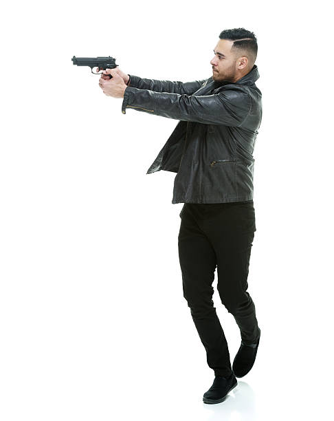 istock Casual man in action with handgun 483333802