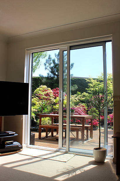 istock Image of aluminium patio doors overlooking back garden with decking 483337996
