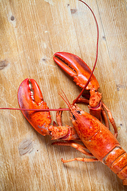 istock Red lobster on wooden table 483341467