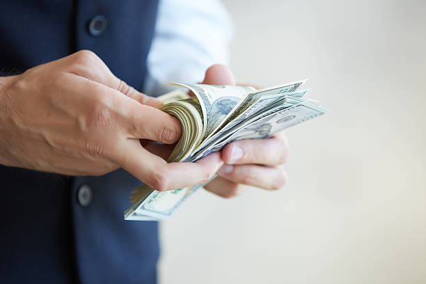 istock businessman holding money 483342462