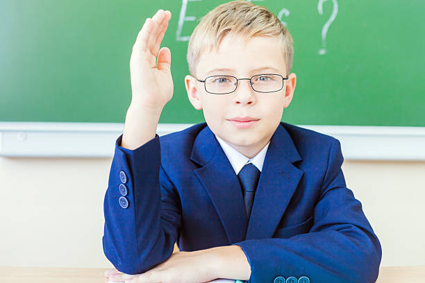 istock Schoolboy ready to answer and raised hand up 483342936