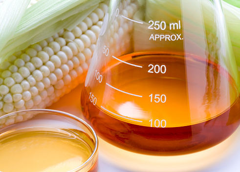 Corn and lab equipment. Concept for biofuel research.