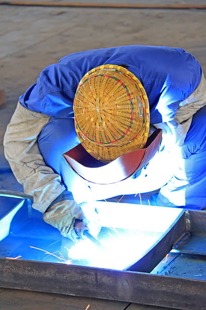 istock workers welding metal components in a factory 483343331