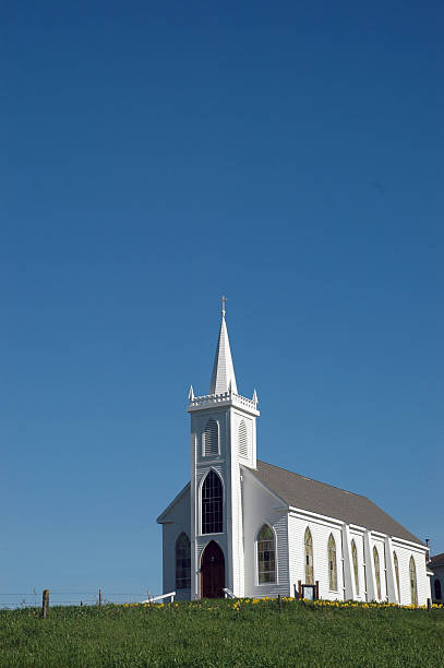 istock white church with blue skies 483343669