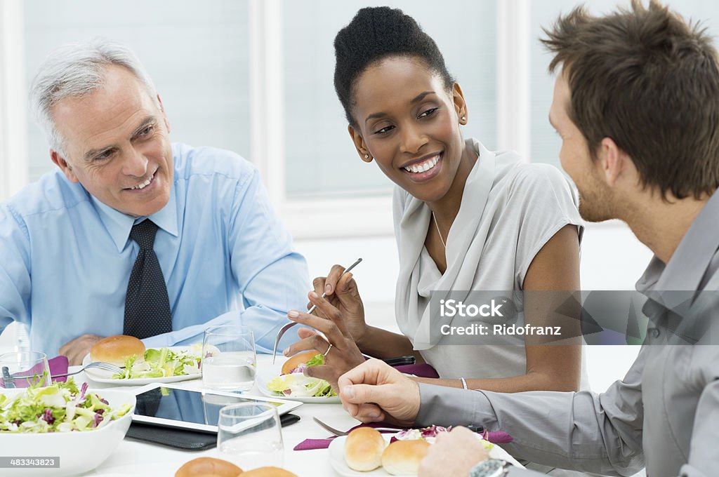 Business Lunch Business Colleagues Eating Meal Together and Discussing of Work Business Lunch Stock Photo