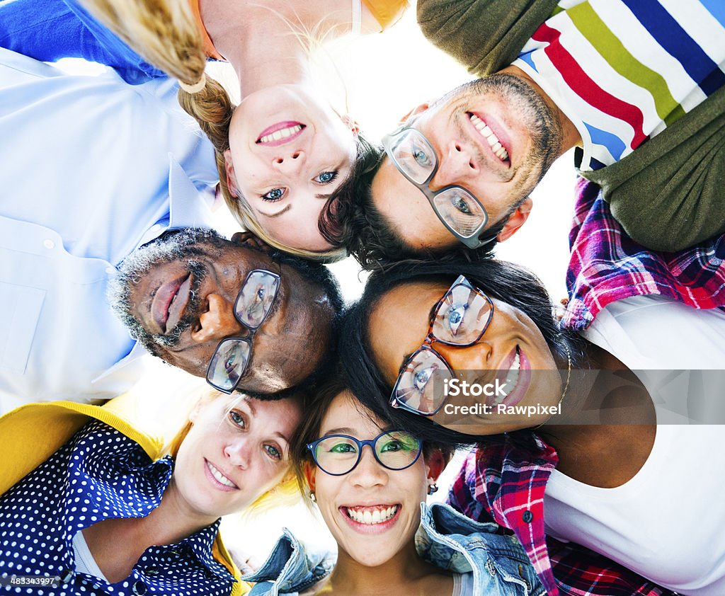 Diverse Group of People with their Heads Together Showing Friendship  Eyeglasses Stock Photo