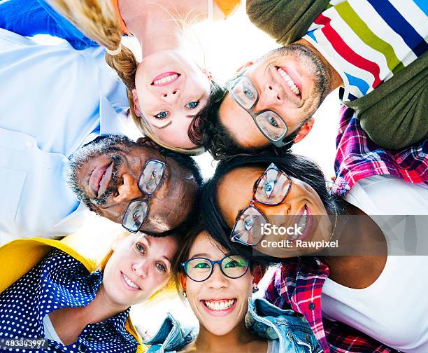 Diverse Group Of People With Their Heads Together Showing Friendship Stock Photo - Download Image Now