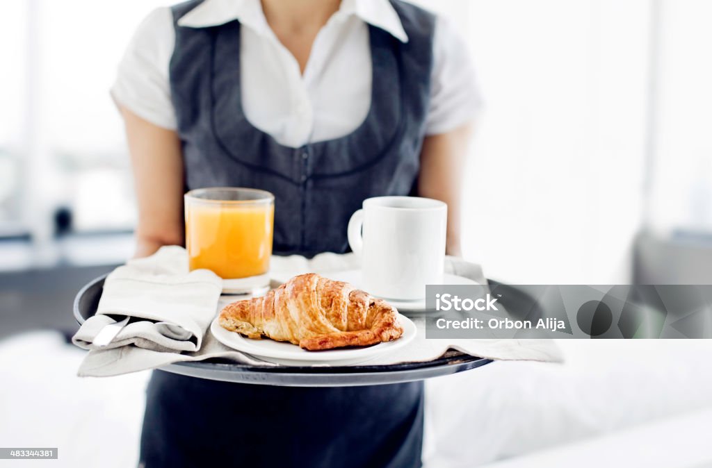 Room service hotel staff carries breakfast tray Hotel Stock Photo