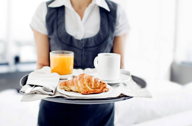 Room service hotel staff carries breakfast tray Room service hotel staff carries breakfast tray room service stock pictures, royalty-free photos & images