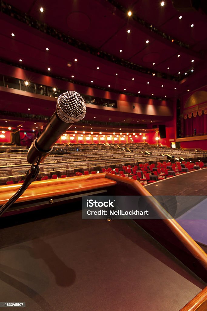 Microphone at Podium in Concert Hall Microphone at Podium in Concert Hall.   Hall is empty and nobody is present. Auditorium Stock Photo