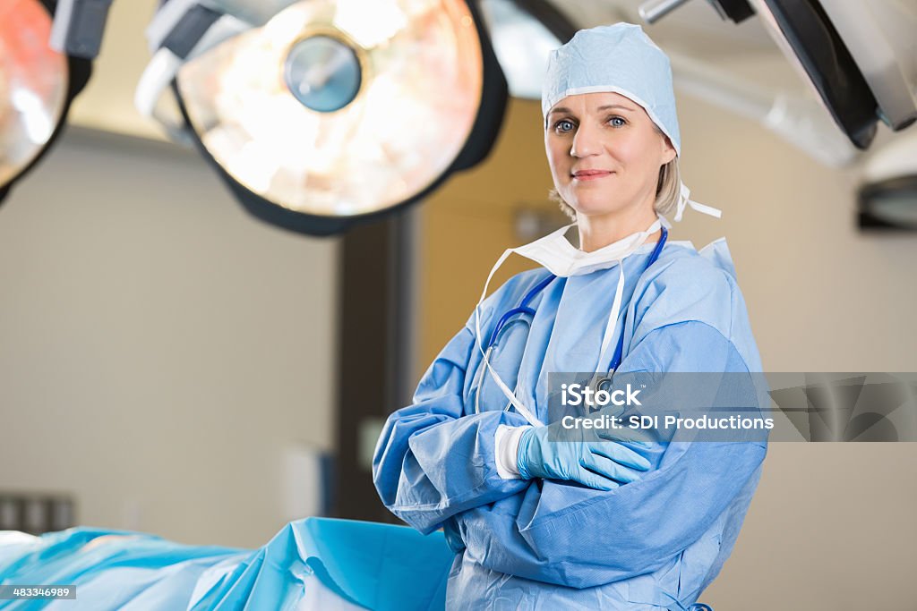 Mature female surgeon in operating room of hospital Surgery Stock Photo