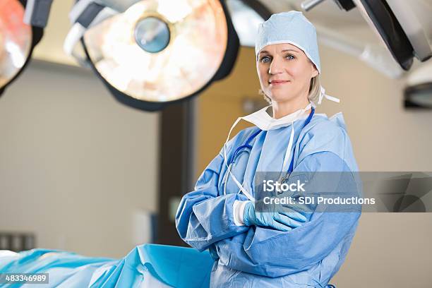 Mature Female Surgeon In Operating Room Of Hospital Stock Photo - Download Image Now