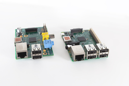 Ljubljana, Slovenia - January 1, 2015: Photo showing a Raspberry Pi version B on the left and new version B+ on the right. New model has 4 USB ports, more memory, larger GPIO connector and some other improvements.