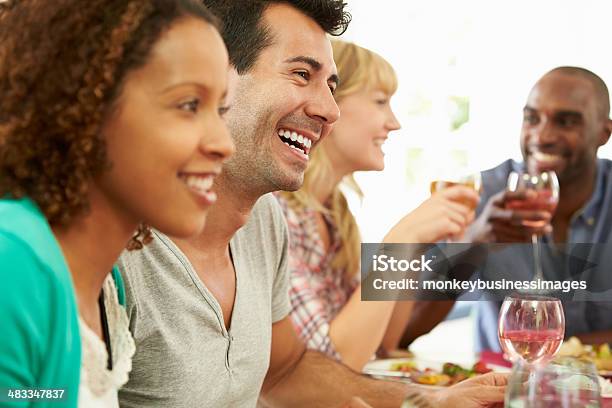 Multiracial Friends Having Fun At A Dinner Party Stock Photo - Download Image Now - 20-29 Years, 30-39 Years, Adult