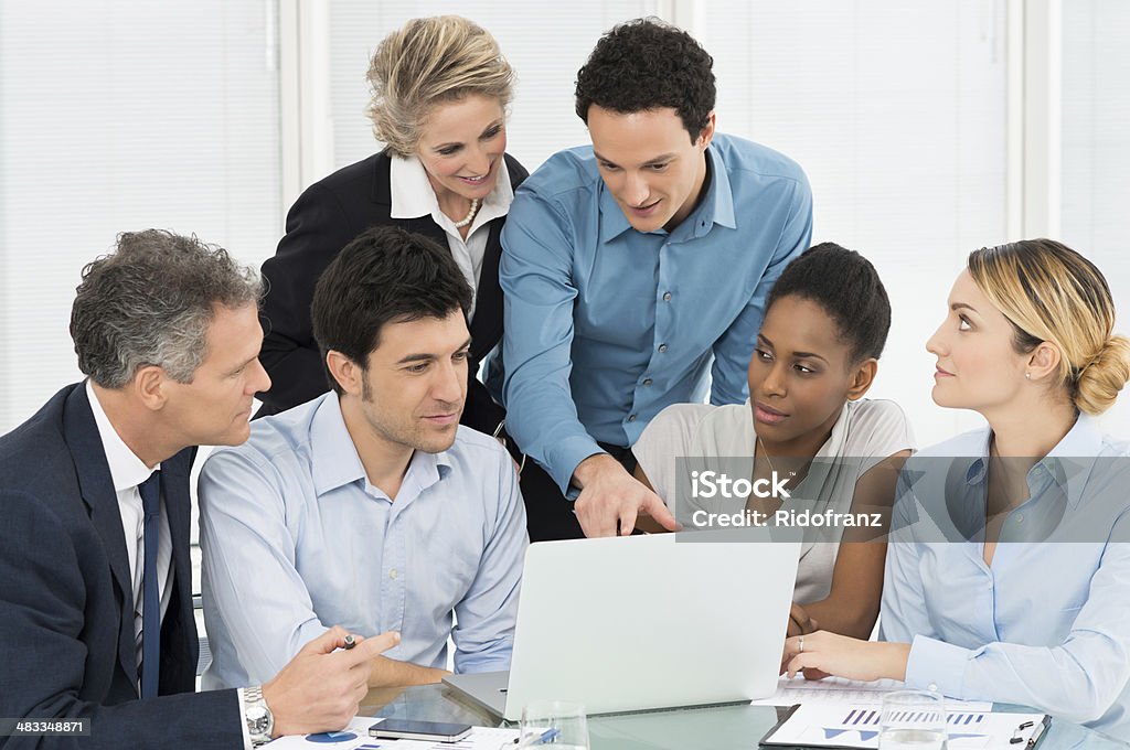 Business Team Looking At Laptop Group Of Businesspeople Using Laptop In Meeting Business Person Stock Photo