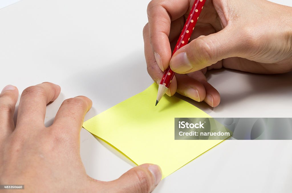 image of hand hold pencil and sticky note close up image of hand hold pencil and sticky note 2015 Stock Photo