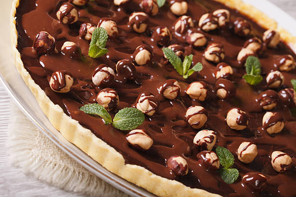istock tart with chocolate and hazelnuts on a table closeup. Horizontal 483359902