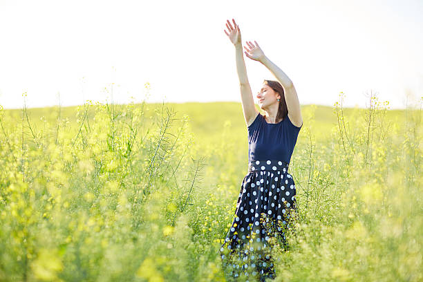 istock girl stands on rapeseed field 483362490