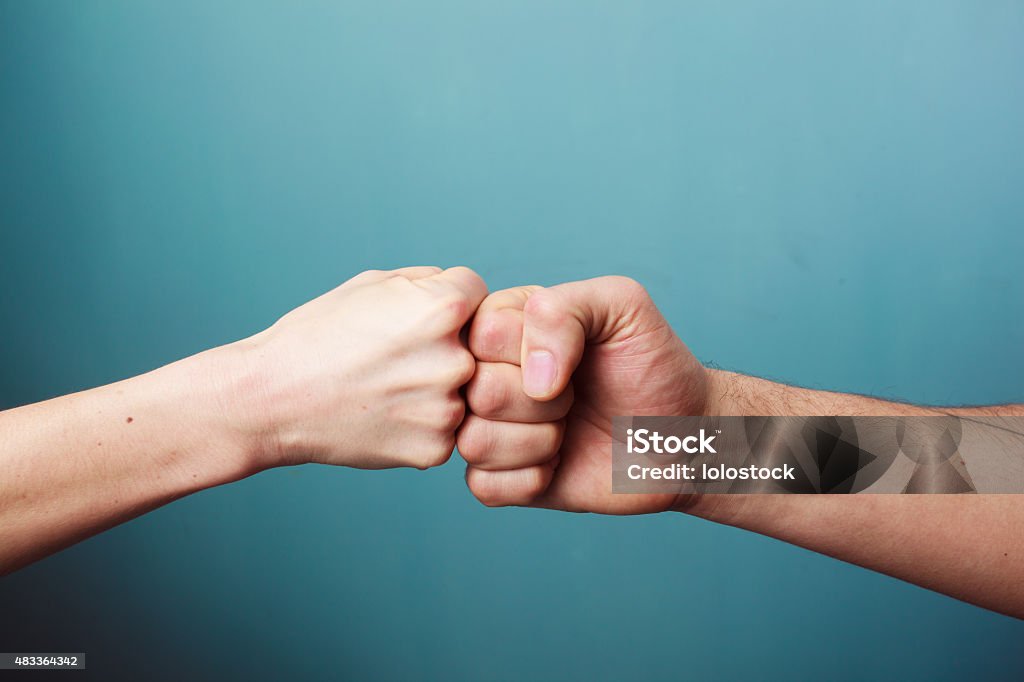Fist bump Young man and woman are fist bumping Fist Stock Photo