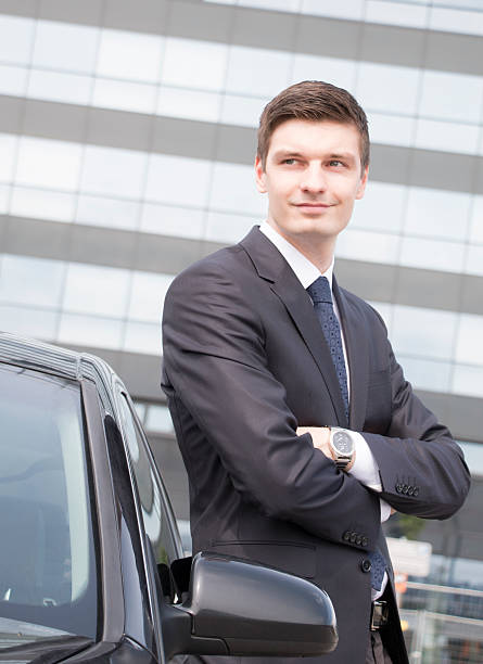 istock Handsome young businessman near his car 483364618