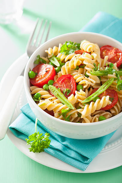 istock vegetarian pasta fusilli with tomato peas herbs 483367246