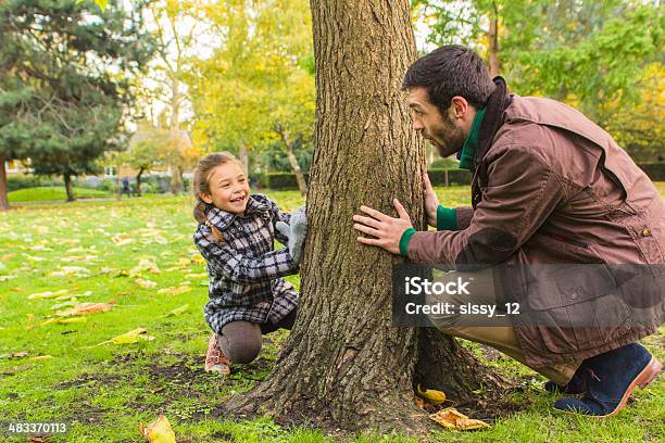 Father And Daughter Playing In The Park Stock Photo - Download Image Now - Family, Peeking, Adult