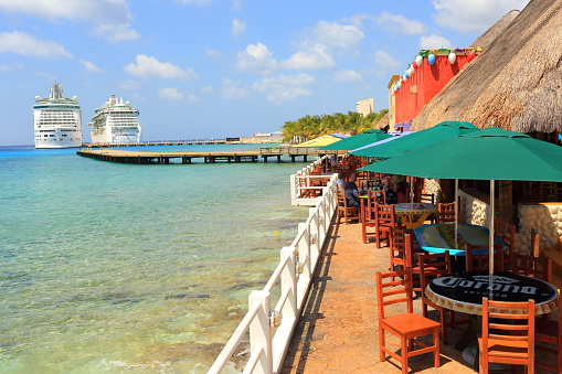 Cozumel, Mexico - April 16, 2013: Cruise Ships Mariner of the Seas and Jewel of the Seas docked at Cozumel, Mexico, which is off the eastern coast of Mexico's Yucatán Peninsula, and is an island in the Caribbean Sea; visitors can be seen everywhere