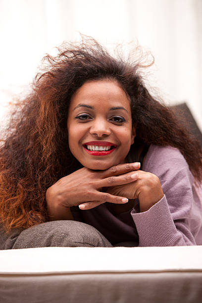istock beautiful young black happy woman on a sofa 483370881
