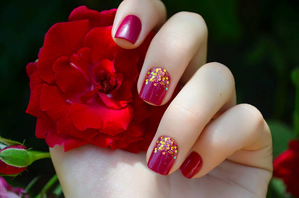 istock Woman hand with sparkle pink manicure 483371206