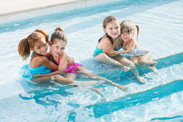 istock Little girls in swimming pool 483371279