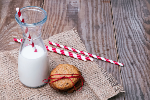 Homemade wholegrain cookies  and milk on the wooden background