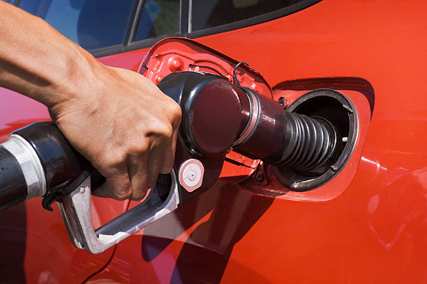istock Man’s Hand Refueling Automobile Gasoline, Filling Car Using Fuel Pump 483371507