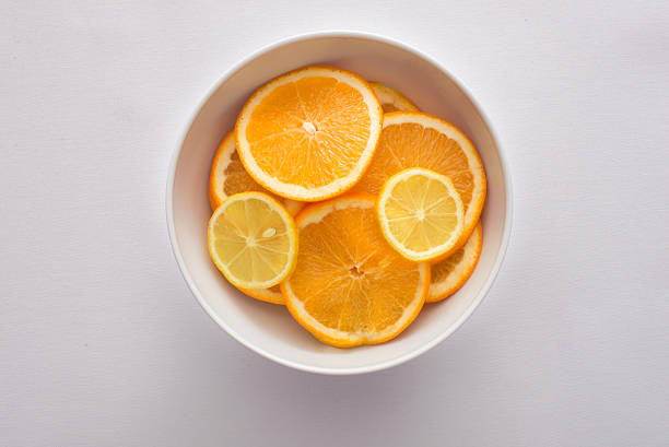 istock orange and lemon slices in a white bowl 483371974
